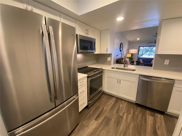 kitchen with stainless steel appliances, dark hardwood / wood-style flooring, sink, and white cabinets