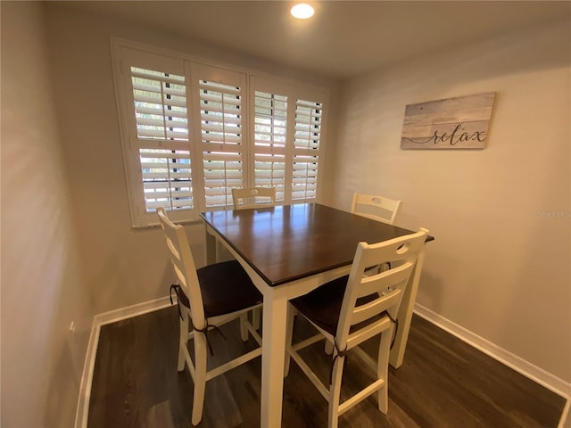 dining room with dark wood-type flooring