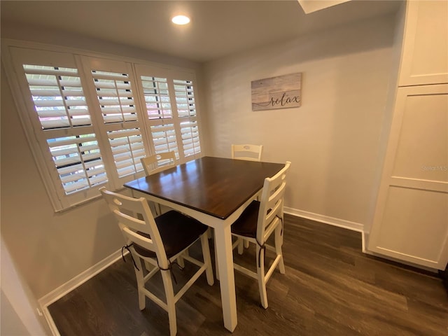 dining space featuring a healthy amount of sunlight and dark hardwood / wood-style floors