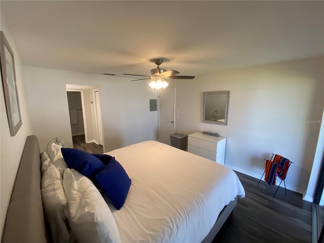 bedroom with dark hardwood / wood-style flooring and ceiling fan