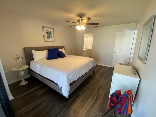 bedroom featuring dark hardwood / wood-style flooring, ceiling fan, and ensuite bathroom