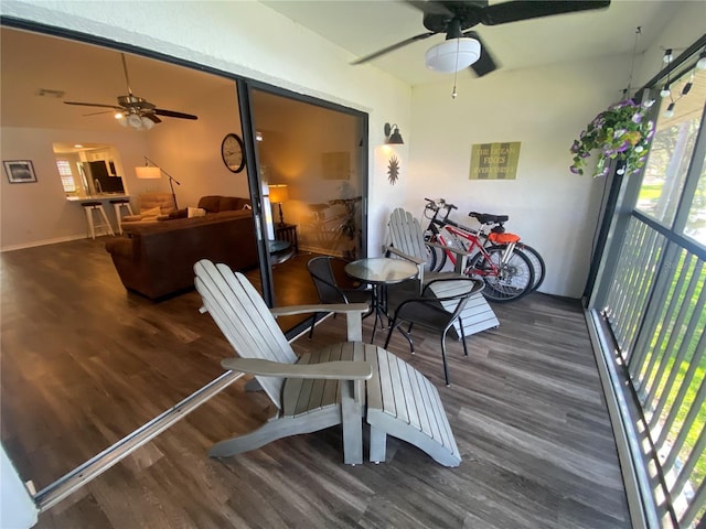 sunroom featuring ceiling fan