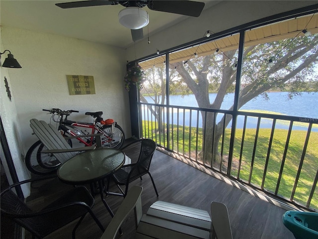 sunroom / solarium featuring a water view