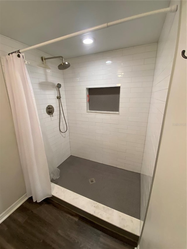 bathroom featuring curtained shower and hardwood / wood-style floors