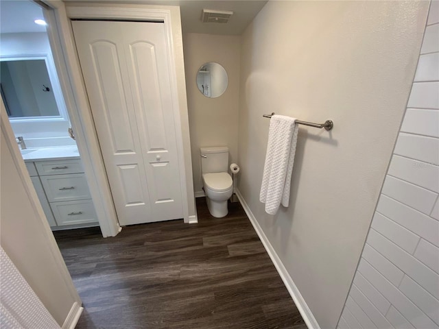 bathroom with vanity, hardwood / wood-style floors, and toilet