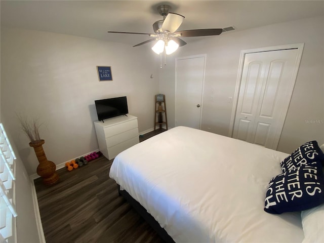 bedroom with ceiling fan and dark hardwood / wood-style flooring