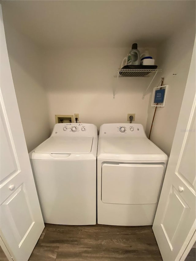 washroom with dark hardwood / wood-style floors and washing machine and clothes dryer