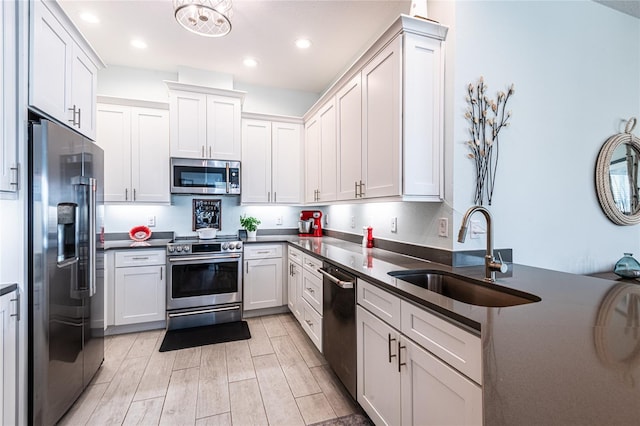 kitchen featuring white cabinetry, stainless steel appliances, and sink