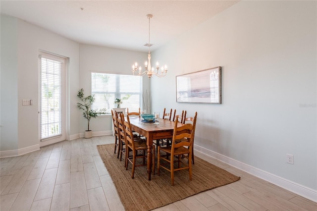 dining area with a chandelier and light hardwood / wood-style flooring