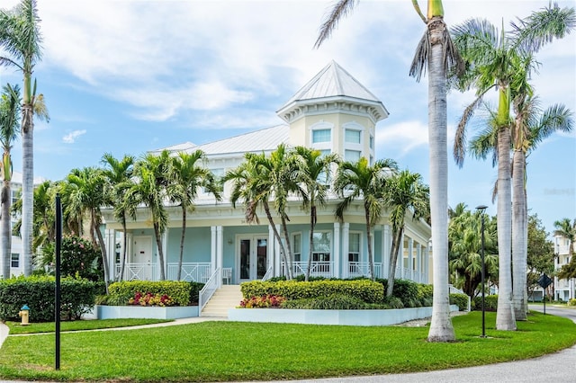 view of front facade featuring a front lawn and french doors