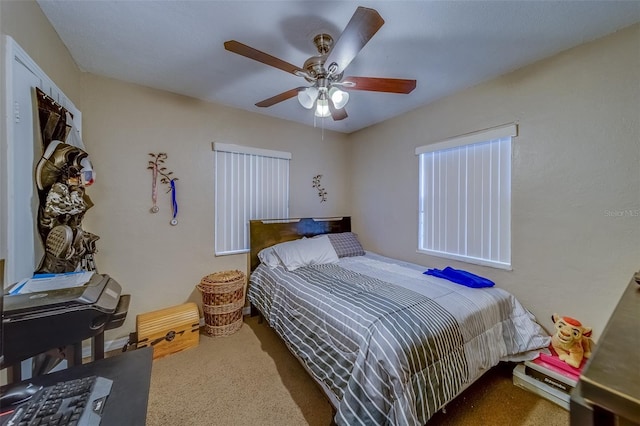 bedroom featuring ceiling fan and carpet