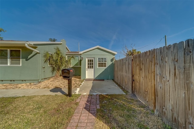 view of home's exterior featuring a lawn and a patio area