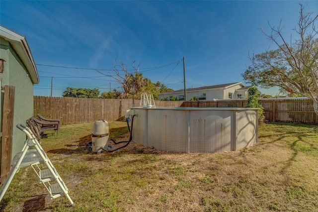 view of yard with a fenced in pool