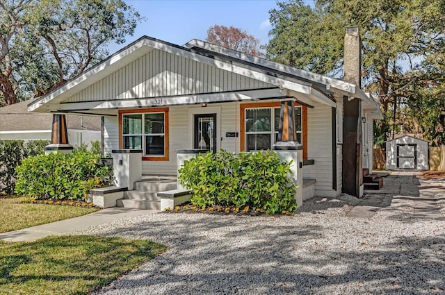 bungalow with a porch and a storage shed