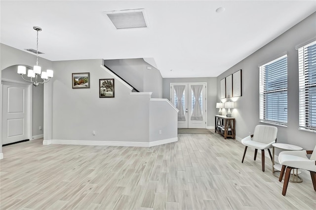 interior space with an inviting chandelier and light hardwood / wood-style flooring