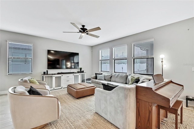 living room featuring ceiling fan and light hardwood / wood-style flooring