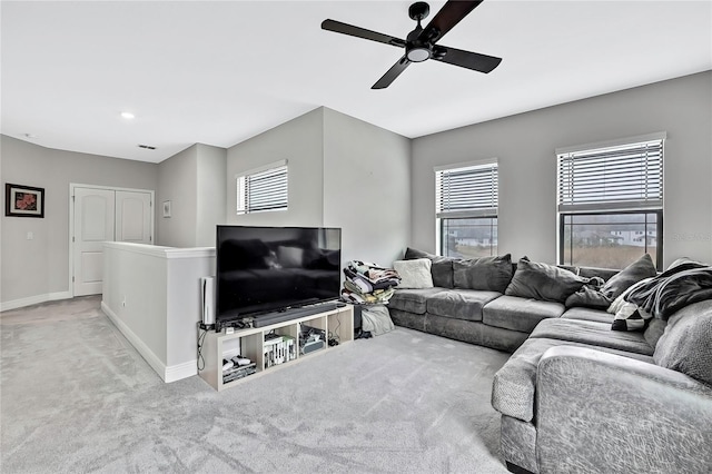 carpeted living room with ceiling fan