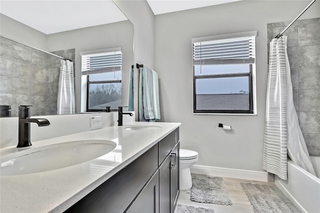 full bathroom with vanity, toilet, wood-type flooring, and shower / bath combo