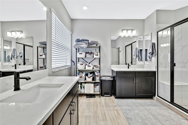 bathroom featuring vanity, a shower with shower door, and hardwood / wood-style floors