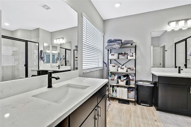 bathroom featuring a shower with door, vanity, and hardwood / wood-style flooring