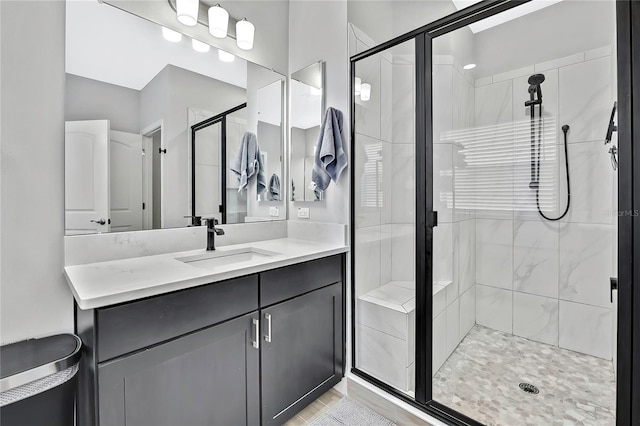 bathroom with vanity and a shower with shower door