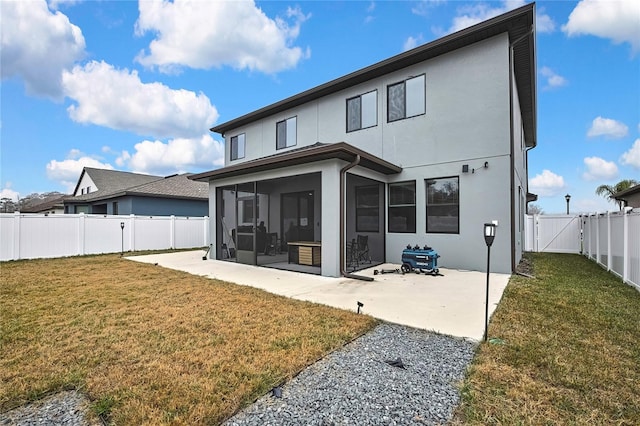 back of property featuring a patio area, a sunroom, and a lawn