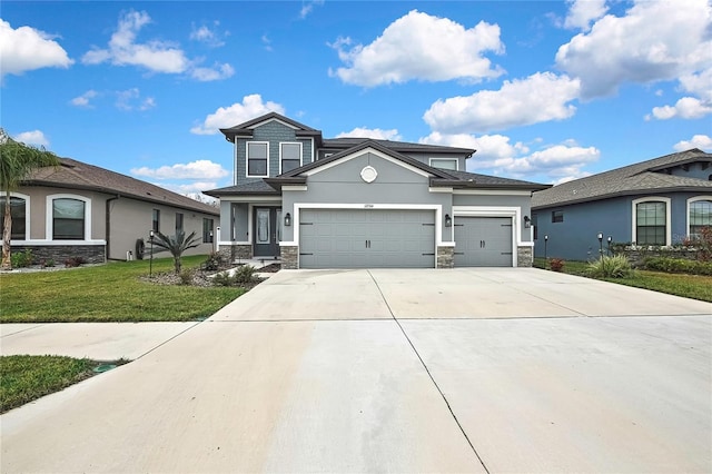 view of front of house featuring a garage and a front lawn