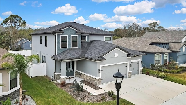 view of front of home with a garage and a front lawn