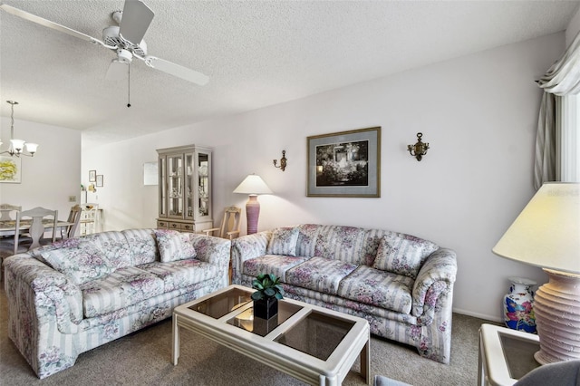 carpeted living room with ceiling fan with notable chandelier and a textured ceiling