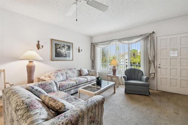 living room with carpet floors, a textured ceiling, and ceiling fan