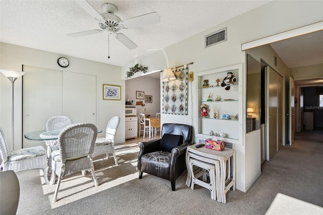 interior space featuring ceiling fan and a textured ceiling