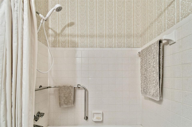 bathroom with shower / bath combination with curtain