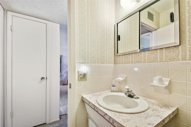 bathroom featuring vanity and tile walls