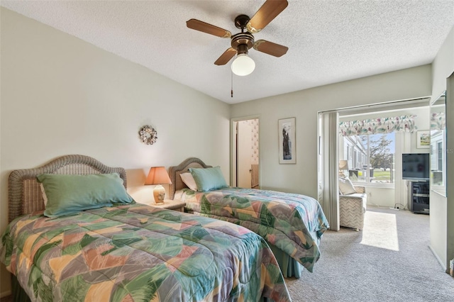 carpeted bedroom featuring ceiling fan and a textured ceiling