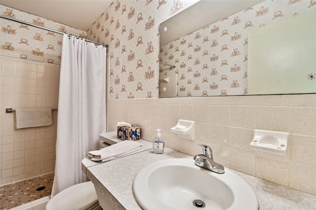 bathroom featuring tile walls, vanity, a shower with curtain, and toilet