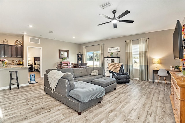 living room featuring ceiling fan and light hardwood / wood-style floors