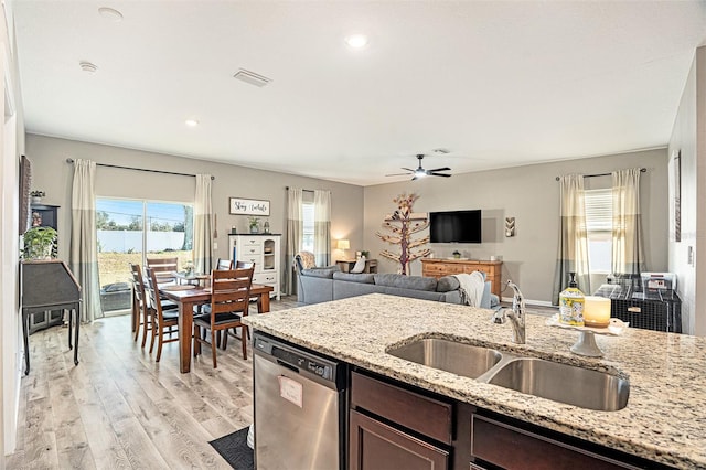 kitchen with sink, light hardwood / wood-style flooring, dishwasher, dark brown cabinetry, and light stone counters