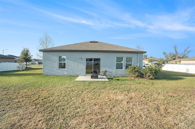 back of house featuring a patio area and a lawn