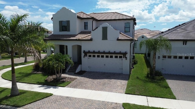 view of front of home featuring a garage and a front lawn