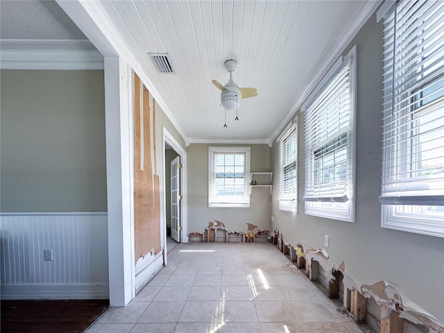 interior space with crown molding, light tile patterned floors, and ceiling fan