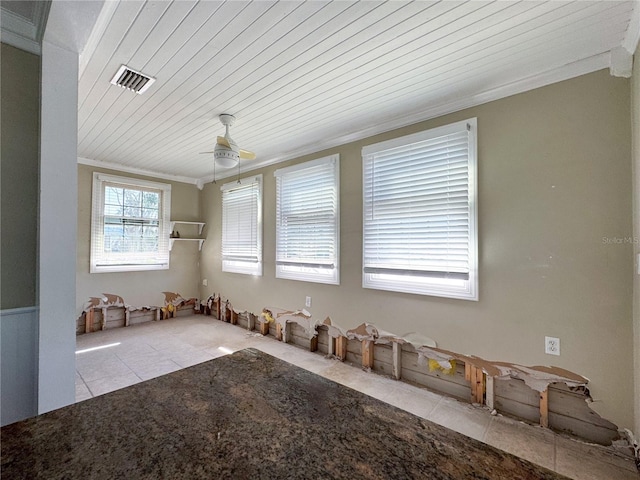 tiled empty room featuring ornamental molding and wood ceiling