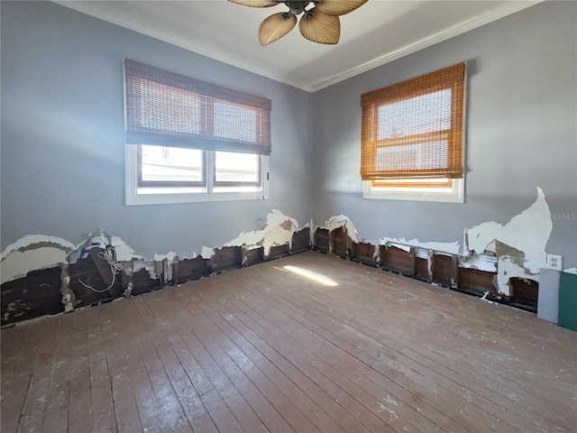 unfurnished room featuring crown molding, hardwood / wood-style flooring, and ceiling fan