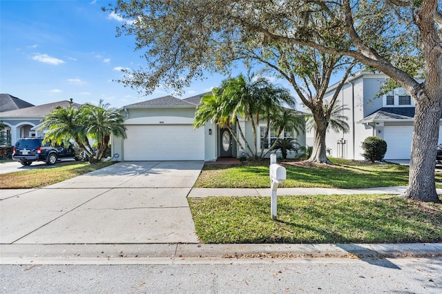 view of front of house featuring a garage and a front lawn