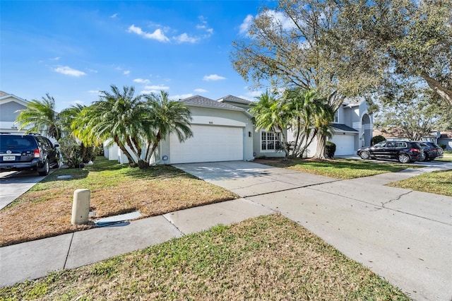 view of front of home with a garage and a front lawn