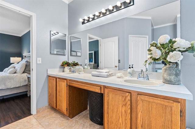 bathroom with ornamental molding, tile patterned flooring, and vanity