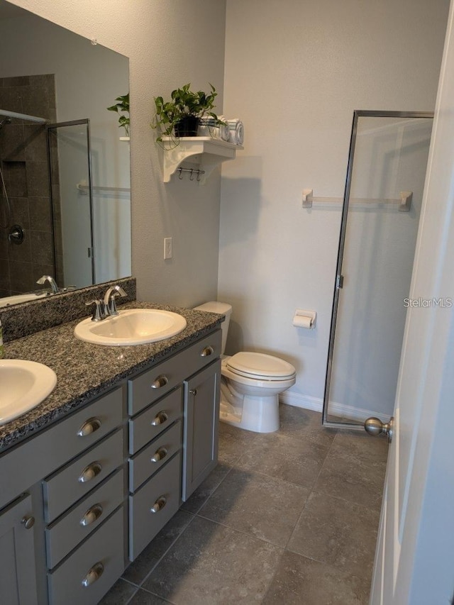 bathroom featuring toilet, vanity, and walk in shower