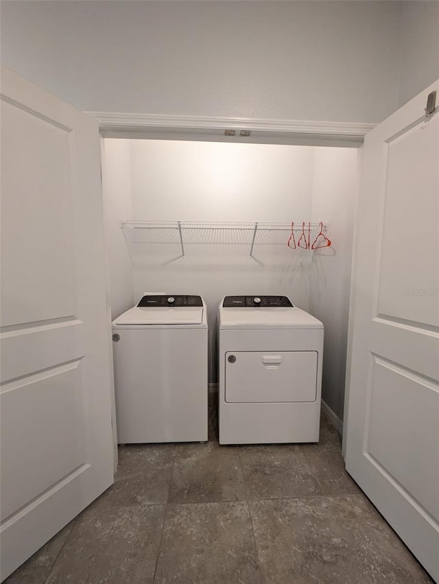 clothes washing area featuring independent washer and dryer