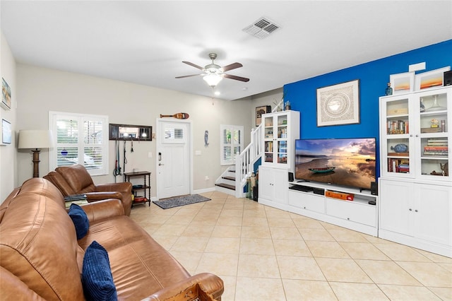 living room featuring light tile patterned floors and ceiling fan