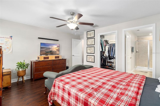 bedroom featuring ensuite bath, ceiling fan, dark hardwood / wood-style floors, a walk in closet, and a closet