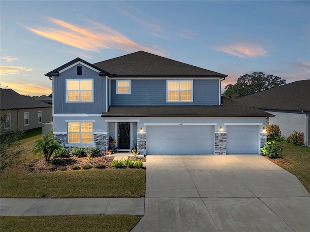 view of front of property featuring a yard and a garage